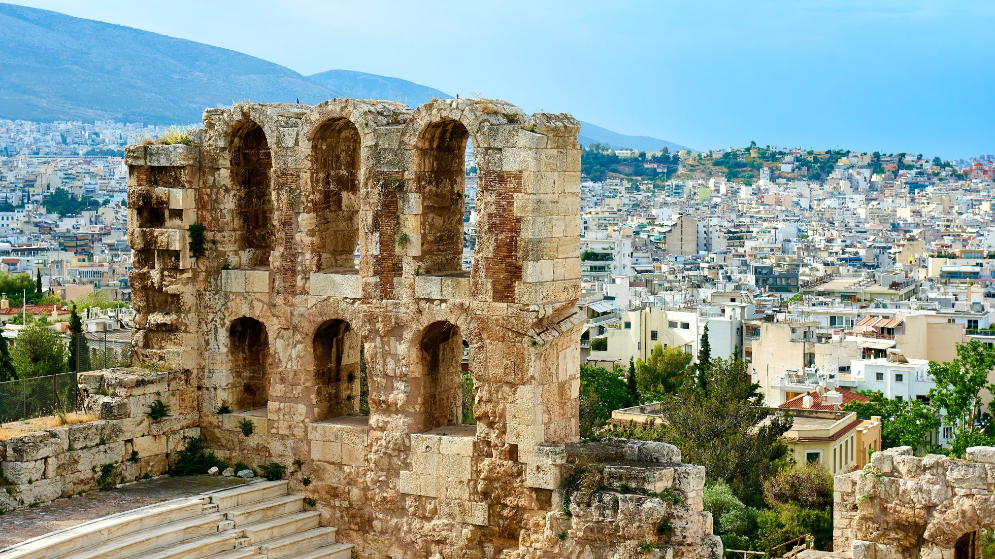 The photo shows a view of the Acropolis in Athens.