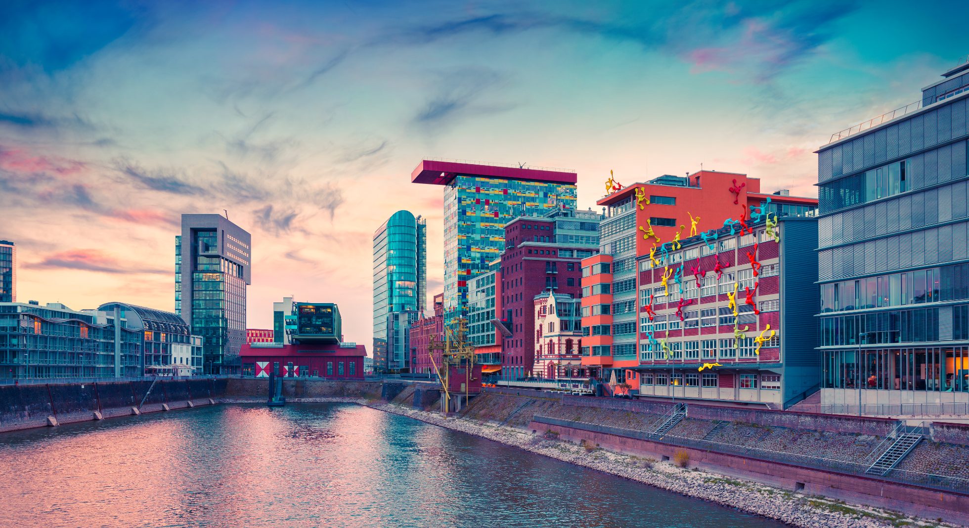 Evening view of the river in Dusseldorf, where to go on vacation in April?