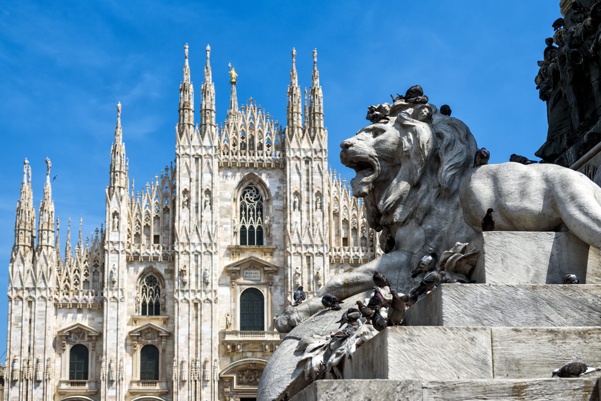 Lion sculpture in Milan's Piazza del Duomo; where to vacation in April?