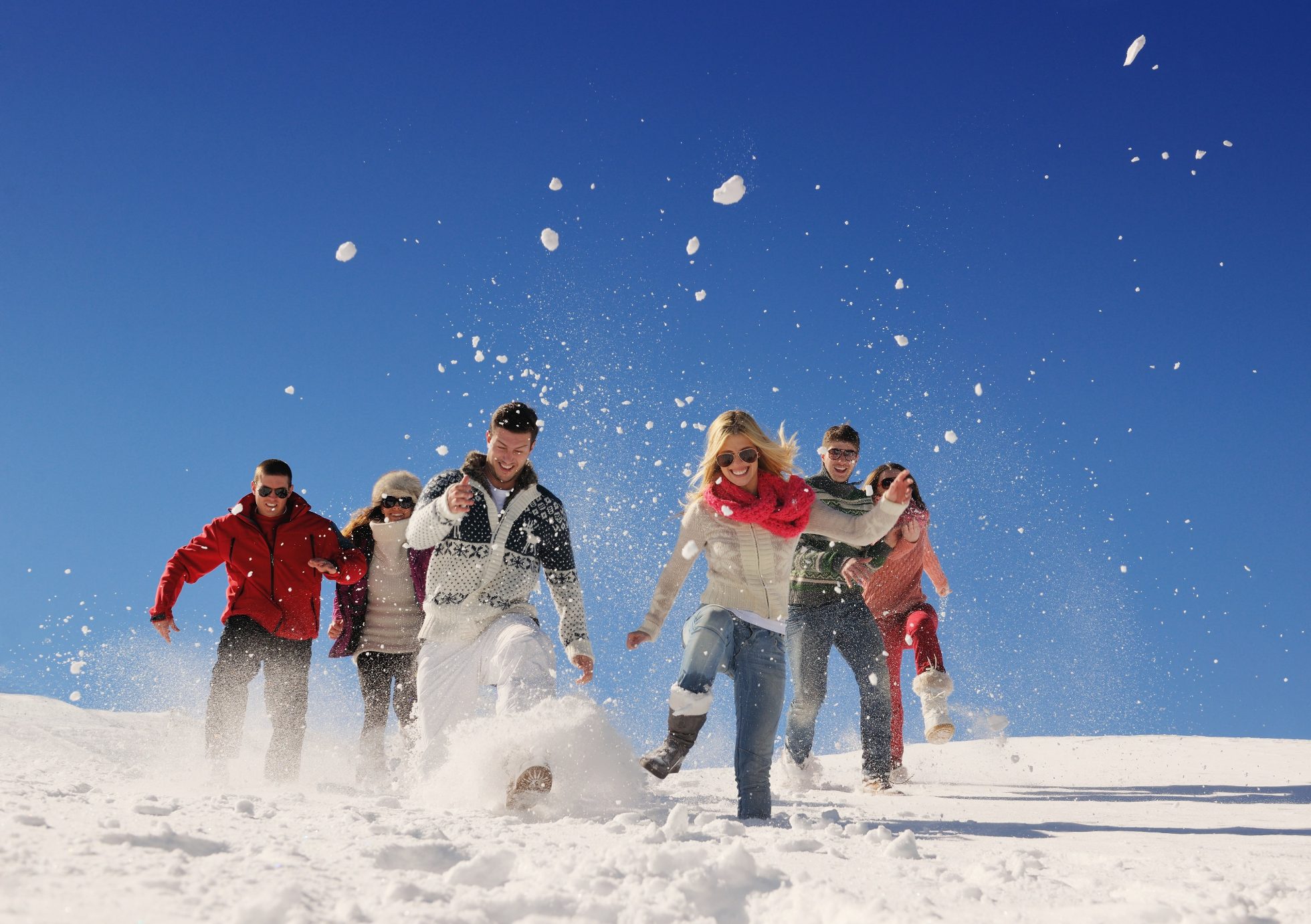 Large group of friends having fun in the snow, group trips vs solo trips, LOT for Groups