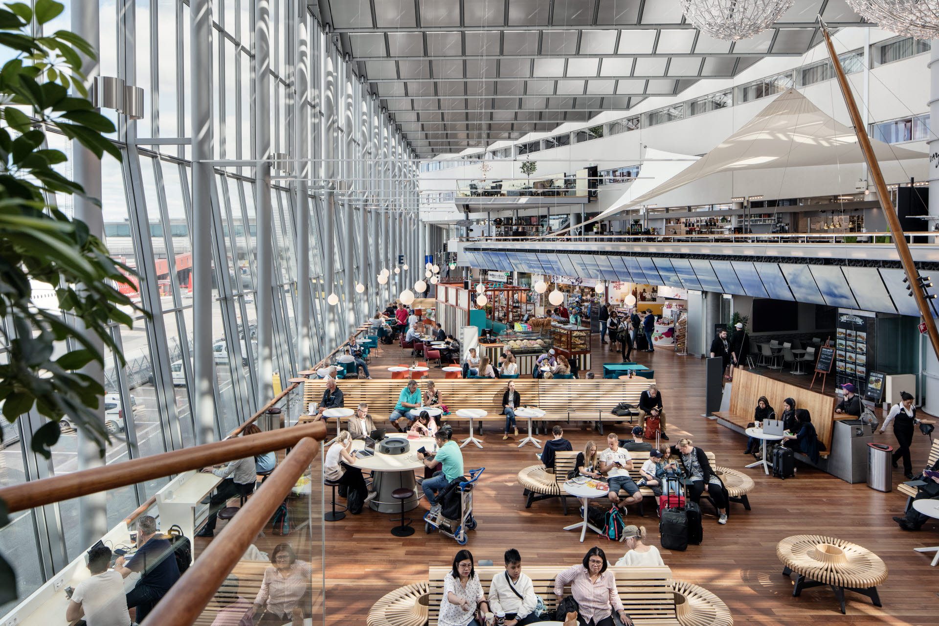 People waiting for the plane in the middle of the airport building