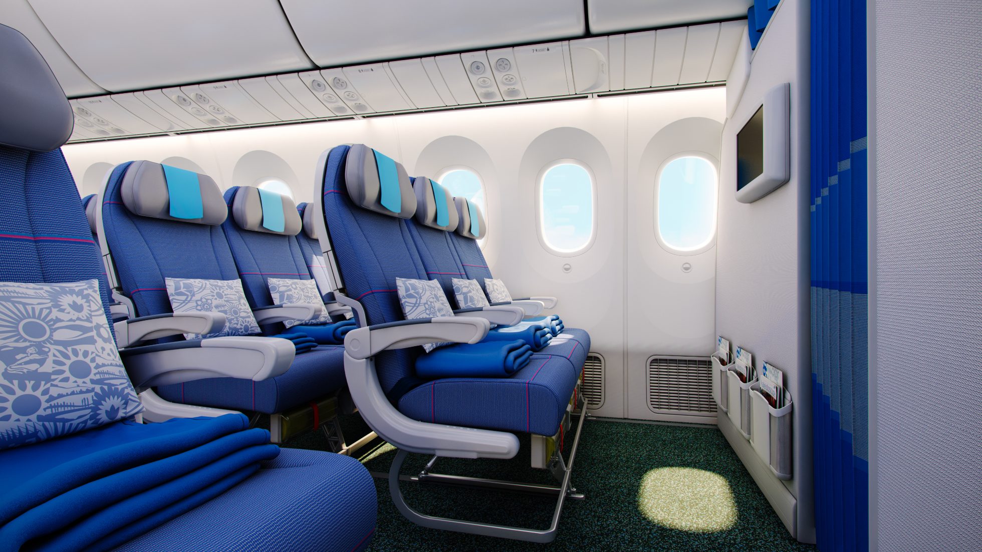 LOT Economy Class w Boeing 787 Dreamliner. Widok na rząd foteli w pierwszym rzędzie tuż za ścianką oddzielającą od Premium Economy.