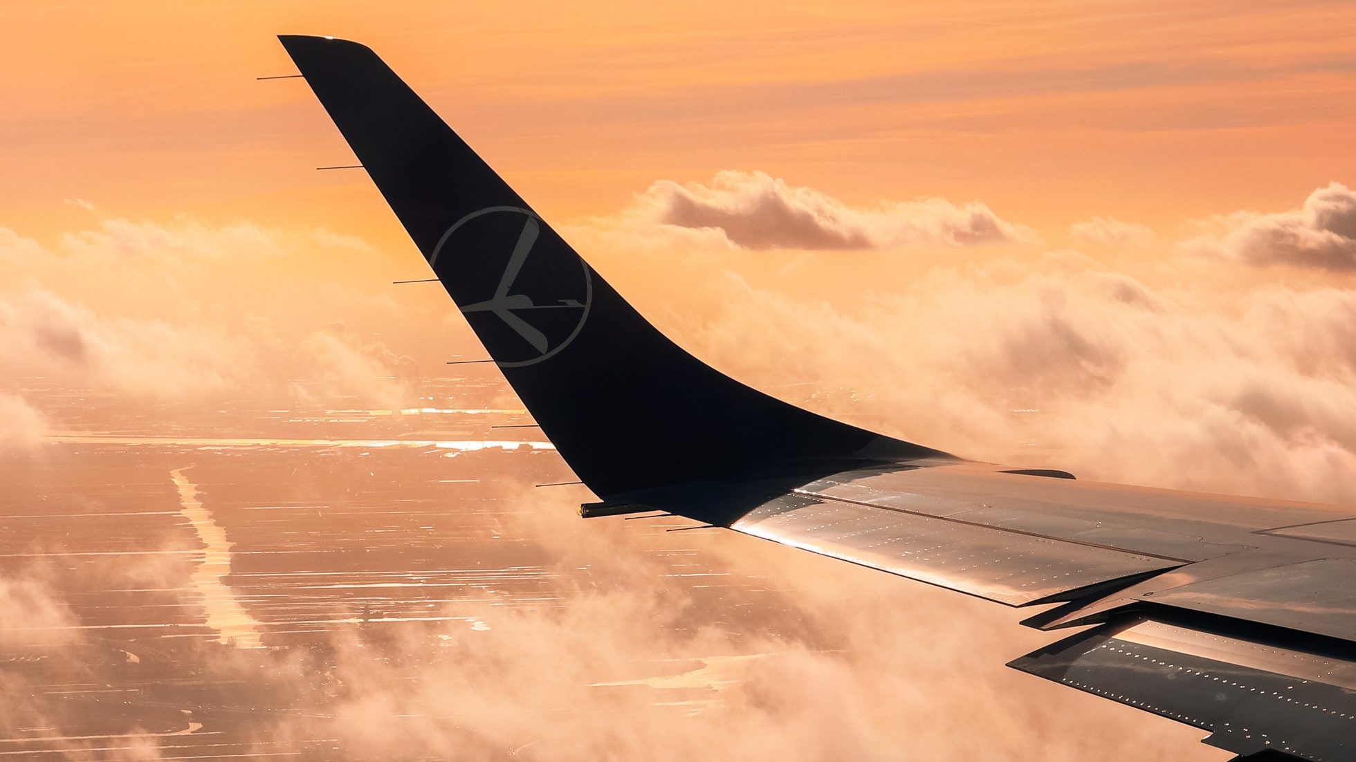 Widok na winglet skrzydła samolotu przy zachodzącym słońcu, czym jest turbulencja