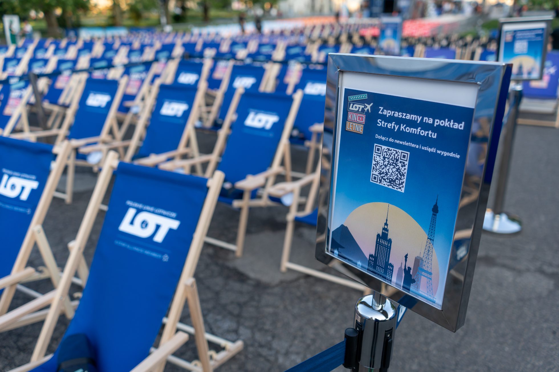 Blue deckchairs with LOT sign in the summer cinema zone under the Palace of Culture and Science