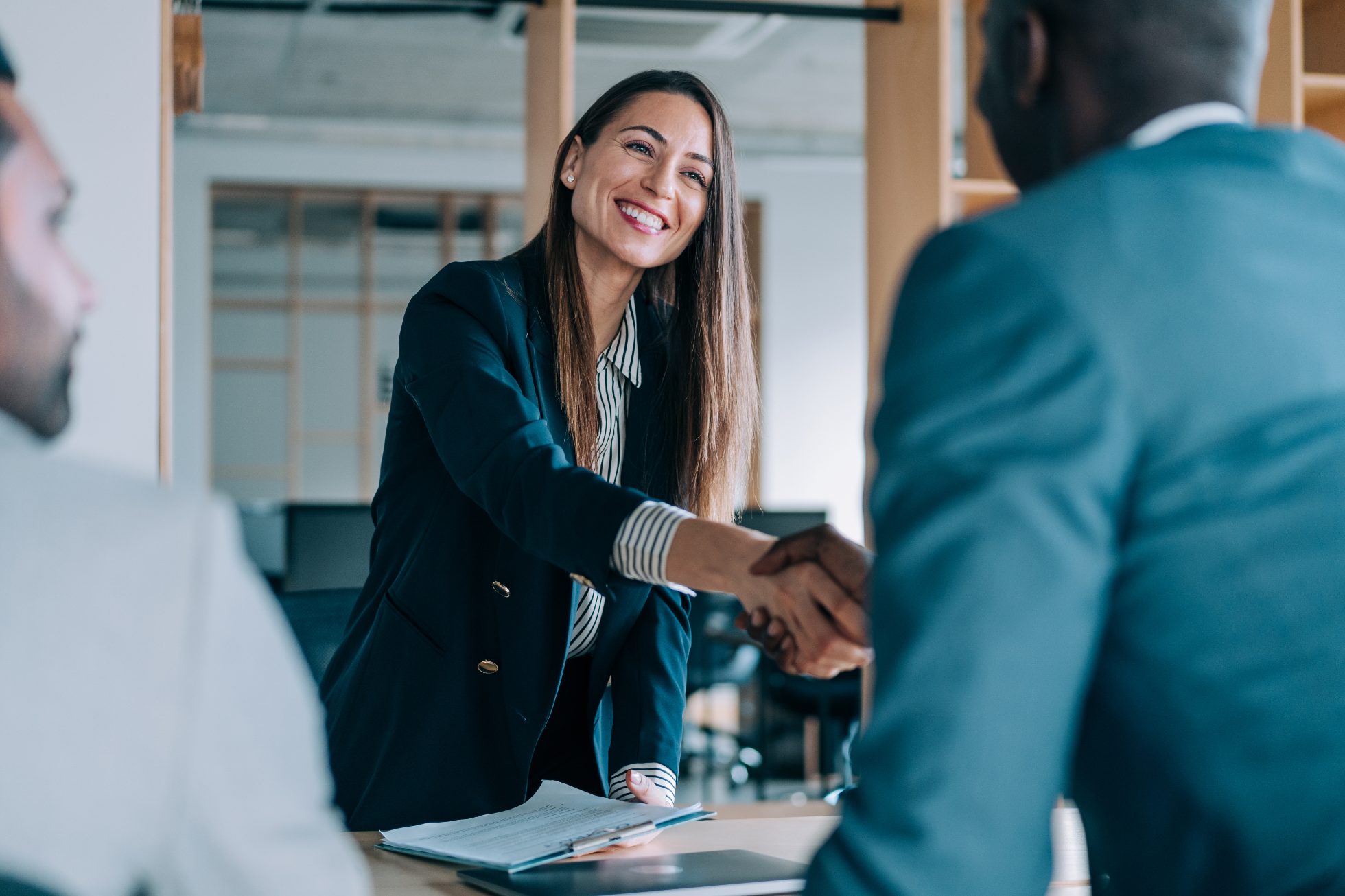 Business partners come to an agreement and shake hands.