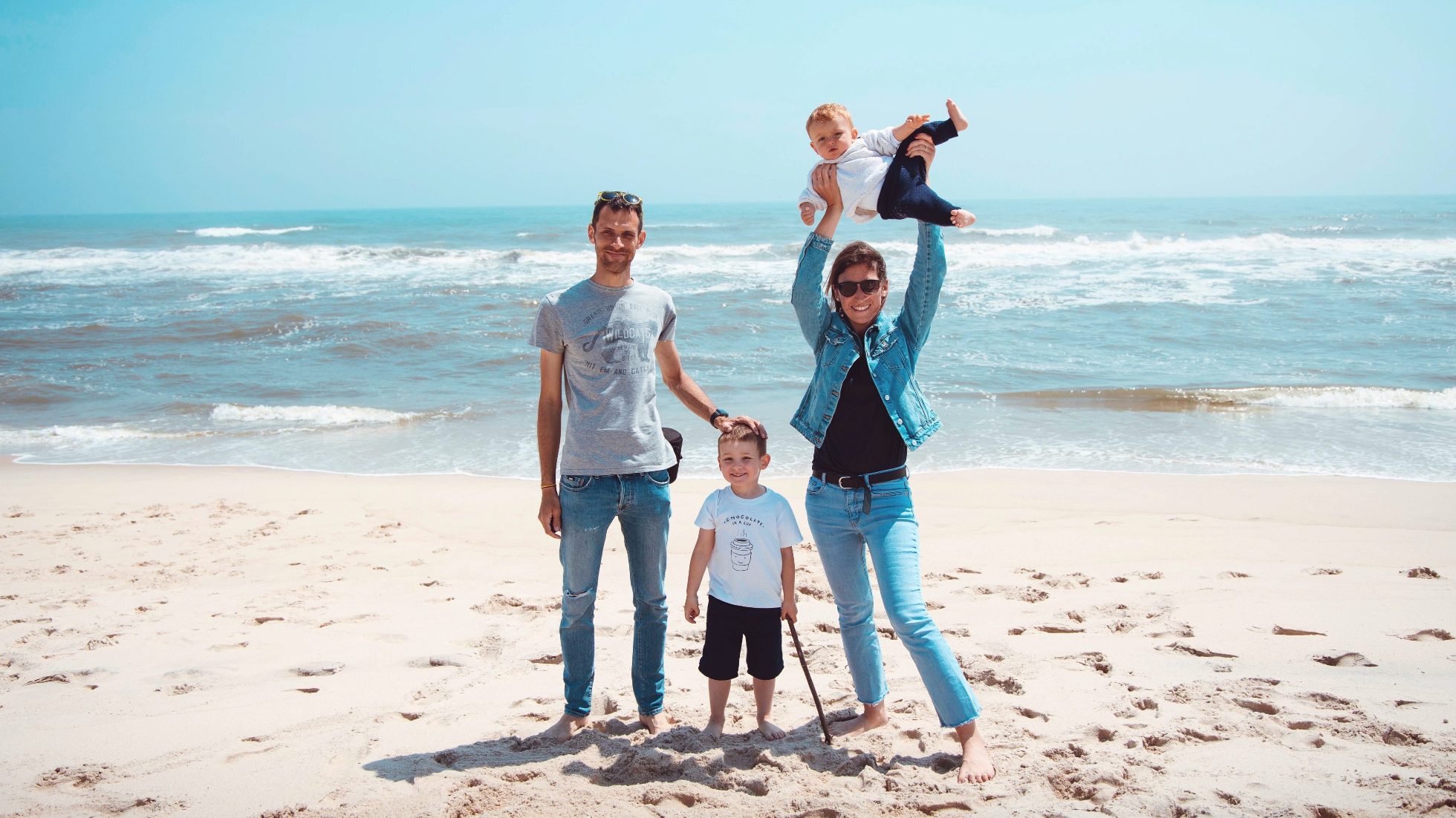 A cheerful family with children on the beach
