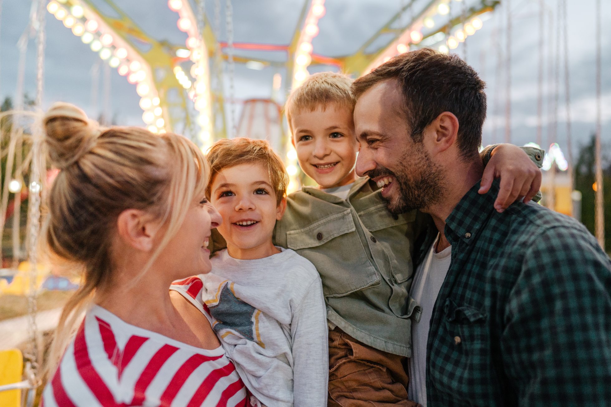 A cheerful family in the amusement park