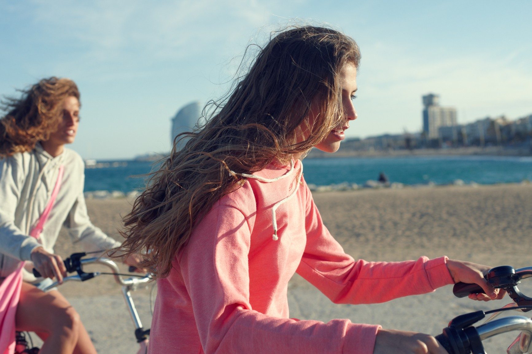Women traveling on bicycles along the Barcelona coast