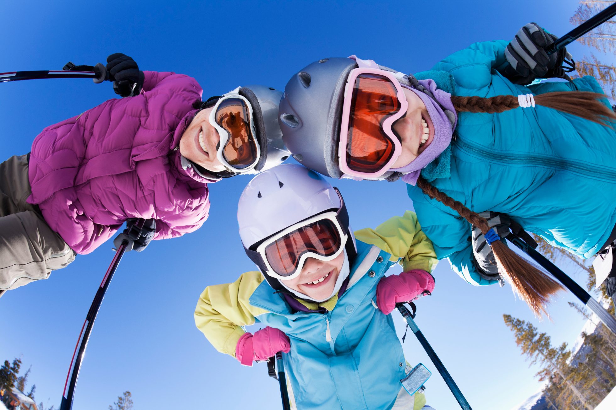 Happy family enjoys winter skiing vacation 