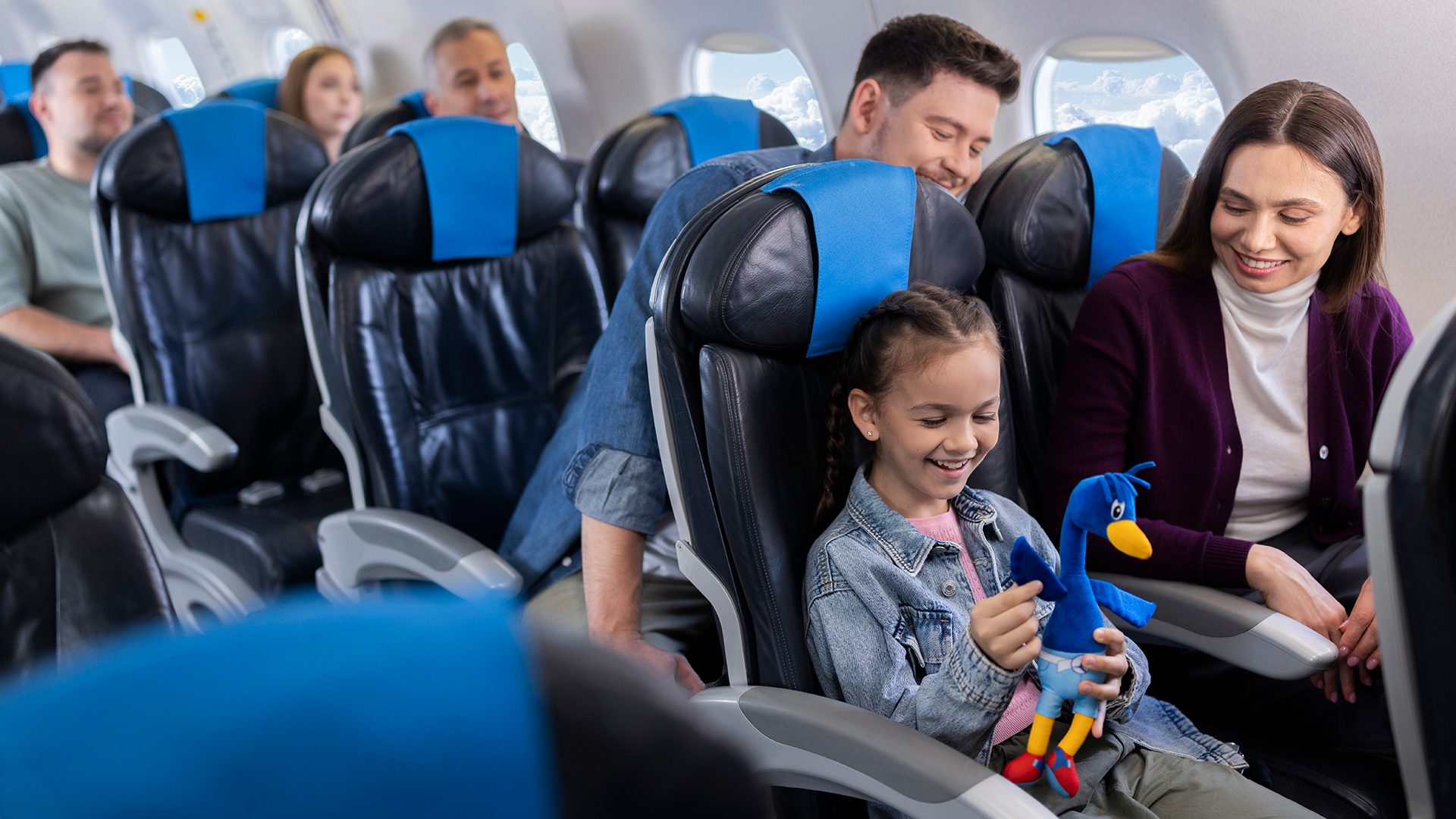 Passengers, including a child with a teddy Lotek, travel aboard an Embraer .